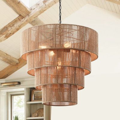 This 26-inch 5-light pendant light is inspired by a coastal aesthetic to add a feature to your setting. The woven rattan shade is made up of four different-sized circular hollow cages, which diffuse the light through its striped rattan pattern. Use this handcrafted pendant chandelier over your dining table or any sitting area in your space for a warm glow. Finish: Brown | Bayou Breeze Aleris 5 - Light Shaded Tiered Pendant, Rattan | Wayfair Wicker Light Fixture Dining Rooms, Huge Chandelier High Ceilings, Large Beaded Chandelier, Oversized Foyer Chandelier, Extra Large Boho Chandelier, Modern Organic Lighting, Large Rattan Chandelier, Rattan Aesthetic, Rattan Chandelier The Home Depot