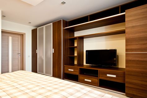 Tv wardrobe design which makes the most out of your designated wardrobe space Wardrobe With Tv Unit, Simple Tv Unit Design, Bedroom Tv Unit Design, Tv Unit Bedroom, Bedroom Tv Stand, Bedroom Wall Units, Bedroom Wardrobe Design, Modern Wall Units, Wall Unit Designs