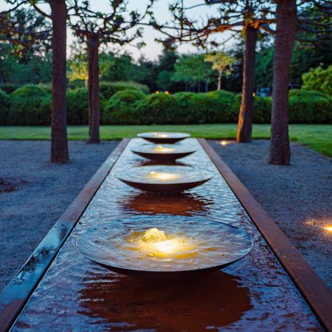 With its contemporary design, the Adezz Corten steel rectangular water bowl table is a distinctive and stylish garden ornament, bringing extra ambience and dynamism to any garden space. This effect is amplified by the water bowls that rest on top of the water table. The water flows over the edge of the bowls, adding life and movement to the garden. The epitome of contemporary shimmering beauty, the integrated LED-lit fountains turn your daytime water feature into a nightmare spectacular, allowin Water Bowl Fountain, Round Water Feature, Water In The Garden, Restaurant Water Feature, Raised Bed Water Feature, Narrow Water Feature, Water Bowl Garden, Water Fountain Backyard, Rectangle Water Feature