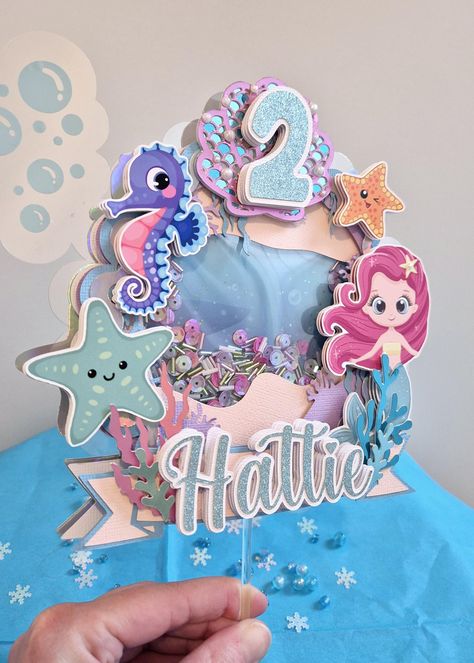 ️ 3D Mermaid Shaker Cake Topper 🐚  Make your celebrations magical and enchanting with this personalised 3D Shaker Cake Topper! This stunning cake topper features intricate details and shimmering finishes to stand out. Perfect for your special occasions. Made with numerous layers of cardstock for added 3D effect which will truly elevate your Cake decoration 🎂  Makes an excellent Keepsake following your celebrations!  Personalised with name and age 😁 Please ensure you check all spelling and gra Photo Birthday Cake, 3d Mermaid, Shaker Cake Topper, Mermaid Cake Topper, Photo Birthday, Mermaid Cakes, Spelling And Grammar, Party Needs, Birthday Cake Toppers