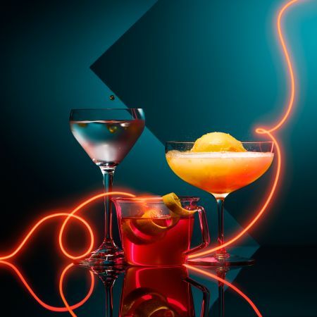 A composition of alcohol cocktails arranged in a night club scene with geometrics shapes and a bright neon light trail dynamically swooping in between the cocktails. For the Dish magazine, Sunday Times. By Dennis Pedersen, Still Life Photographer, London Neon Cocktails, Cocktail Shoot, Neon Food, Latin Grammys, Mocktail Recipes, Cocktail Photography, Cocktail And Mocktail, Water Ice, Light Trails