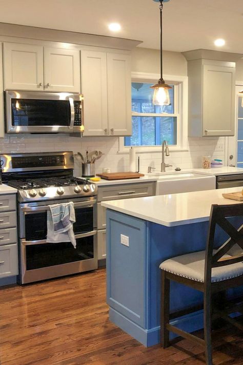 A Smoky Blue island adds a simple but sweet pop of color to this Willow Gray kitchen by Cabinets.com designer Cally. Kitchens Blue Cabinets, Gray Kitchen Cabinets Blue Island, Light Blue Kitchen Cabinets Dark Counters, Blue Island Kitchen Grey Cabinets, Grey Cabinets Navy Island, Gray Cabinets Blue Island, Gray Cabinets With Blue Island, Gray Kitchen Cabinets With Blue Island, Grey And Blue Kitchen Cabinets