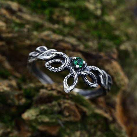 Handcrafted from sterling silver, our Emerald Elven Branch Wedding Ring for women is an enchanting and unique piece that embraces the magic of nature. With intricate details of a branch, vine, and delicate emerald, this fantasy engagement ring captures the essence of an enchanted forest. The silver leaf design adds a touch of elegance to this nature-inspired ring, making it a unique and timeless jewelry piece. Ideal for those seeking an elven aesthetic or a woodland gift. Characteristics: Metal - Recycled solid sterling silver  Stone - Cubic Zirconia Finish - Oxidized. View all silver elven rings: https://www.etsy.com/shop/TinyShinyJewel?ref=seller-platform-mcnav&section_id=47130640 Care instructions: To care for the ring, avoid contact with water and chemicals such as perfumes and lotions Enchanted Forest Wedding Rings, Emerald Jewelry Silver, Fantasy Inspired Rings, Fantasy Rings Aesthetic, Silver Nature Inspired Wedding Ring, Nature Inspired Wedding Rings, Elven Ring Engagement, Emerald Ring Silver, Enchanted Forest Ring