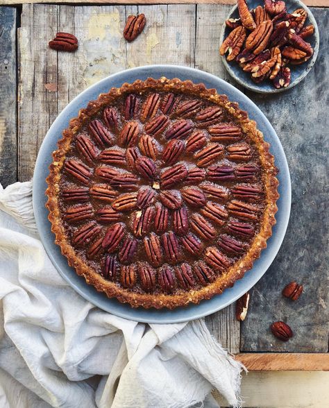 This eggless caramel pecan tart is a family favorite- we all love it at home. The tart shell, that I made with oats this time, is nice and crunchy but my favorite part has to be the gooey caramel with pecan nuts. If you don’t have pecans on hand, you can use any nuts that you like- almonds, hazelnuts, walnuts or even cashew nuts! Bake With Shivesh, Pecan Tart, Walnut Pie, Pecan Tarts, Caramel Filling, Pecan Rolls, Gooey Caramel, Caramel Tart, Eggless Recipes