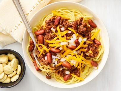 Cincinnati-Style Chili Recipe | Food Network Kitchen | Food Network Chili Recipe Food Network, Cincinnati Style Chili, Chili Food, Oyster Crackers, Canning Diced Tomatoes, Chili Cook Off, Food Network Magazine, Beef Chuck, Unsweetened Chocolate