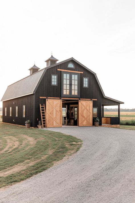 Barndominiums offer a unique blend of rustic charm and modern design. Their versatility makes them ideal for various purposes, from living spaces to functional barns. Black barndominiums, in particular, have gained popularity for their sleek, bold look that complements natural surroundings. In this article, we’ll explore different black barndominium exterior ideas that showcase a range… Horse Ranch Exterior, Horse Barndominium Ideas, Small Barndominium Ideas Interiors Farmhouse, Barndominium Ideas Exterior Rustic, Barndominium Aesthetic, Barndominium Wrap Around Porch, Gray Barndominium Exterior, Barndominium Styles, Dark Barndominium Exterior