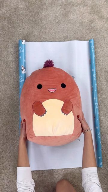 LENNIA (Folding Queen 👑) on Instagram: "How to gift wrap an oversized squishmallow (20 inches) #wrappinghack #wrappingpresents #giftwrapping" Stuffed Animal Gift Wrapping Ideas, Gift Wrap Stuffed Animal, Wrapping Stuffed Animals How To, How To Wrap Plushies, How To Wrap Stuffed Animals Gift, How To Wrap A Stuffed Animal Present, How To Wrap A Squishmallow, Gift Wrapping Stuffed Animals, Wrapping A Stuffed Animal Gift