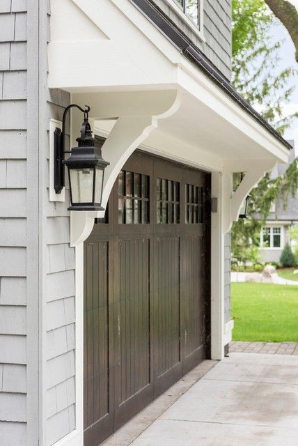 Detached Garage Colors Exterior, Garage Overhang Roof, Eyebrow Garage Door, Pergola Door Awning, Eyebrow House Exterior, Corbels Over Garage Door, Garage Overhang Ideas, Garage Corbels, Roof Over Garage Door