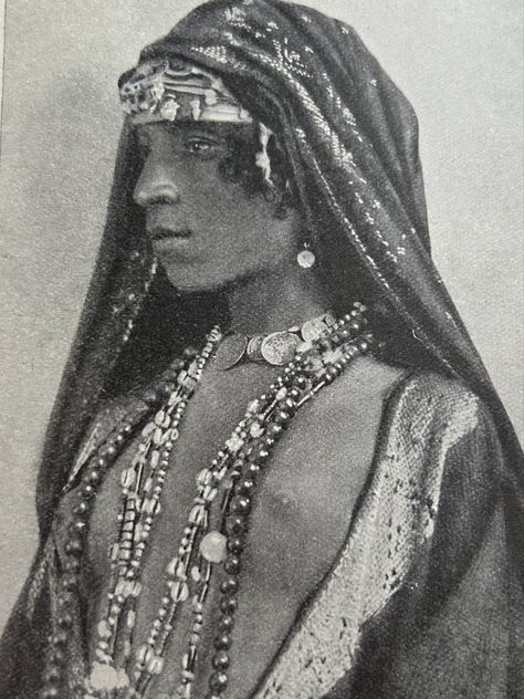 Wearing an embroidered head shawl, worn over a bejewelled turban, necklace of coins, earrings and coloured strings. Picture taken from the book People of all Nations. Arab Hat, Egyptian Headdress, Egyptian Hairstyles, Egyptian Aesthetic, Egyptian Accessories, Egyptian Clothing, 90s Runway, 90s Runway Fashion, Vogue Archive