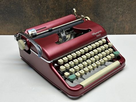 ✨ New Arrival! Red Olympia Monica Typewriter ✨ Description: 📜 Key Features: Experience the elegance and charm of vintage typing with the Red Olympia Monica typewriter! This stunning and durable typewriter is perfect for collectors and writing enthusiasts alike. 🎉 🖋️ Elegant Design: The vibrant red color and classic design of the Olympia Monica add a nostalgic touch to your workspace. 🖋️ Durable Build: Robust and high-quality mechanism ensures long-lasting, trouble-free use. 🖋️ Portable: Li... 1940s Typewriter, Red Typewriter, Modern Typewriter, Keyboard Layout, Qwerty Keyboard, Antique Typewriter, Claret Red, Vintage Type, Fedex Express