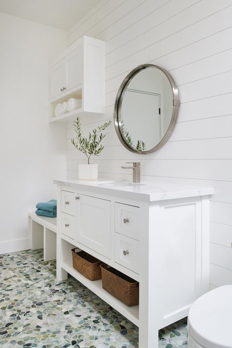 #poolbathroom #poolbath #poolhouse #poolhousebath #whitewalls #whitepaint #whitevanity #whitepaintedvanity #benchseating #millwork #shiplap #custom #customhome #customvanity #openshelvingvanity #whitecountertop #pebbleflooring #pebbletile #pebblebathroomtime #greenpebbles #rockflooring #rocktile #bathroom #bathroomdesign #design #interior #interiors #interiordesign #homewithstyle #onlyprettythings #kellyferm #kellyfermhome #roundmirror #bathroommirror #olivetree #smallolivetree #singlehandfaucet Stone Flooring Bathroom, Pool Bathroom Design, Poolhouse Bathrooms, Poolhouse Bathroom, Bathroom Design White, Small Pool House, Pebble Stone Flooring, Pool House Bathroom, Flooring Bathroom