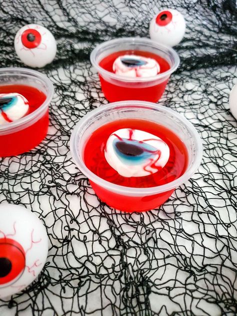 Eerie! Spooky! Wacky! These are just some of the expressions your guests should have this coming Halloween. Nothing on the menu will achieve that expression as compared to these Eyeball Jello Shots. These deliciously boozy treats are perfect for a spooky Halloween party.Making these Eyeball Jello Shots is surprisingly easy and straightforward. However, note that the recipe includes alcohol and is not fit for kids. By now, you probably have a lot of questions concerning the Eyeball Je… Adams Family Snacks, Eyeball Treats Halloween, Halloween Diy Crafts For Adults, Halloween Treat Diy, Hello Shots Halloween, Halloween Jello Ideas, Halloween Food Board Ideas, Eyeball Jello, Halloween Jello Shots