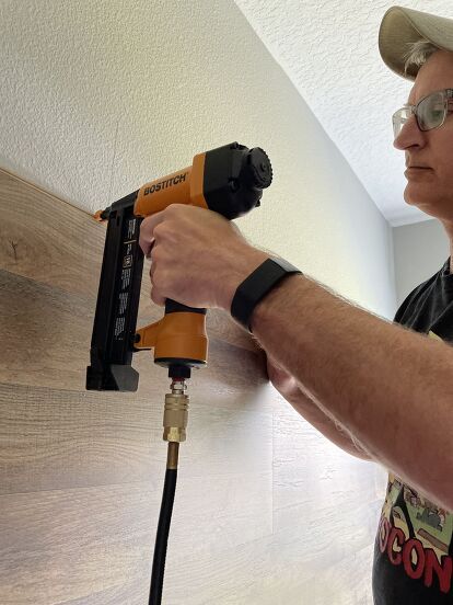 If you want to make a huge impact in a room, consider adding a wood feature wall. It's a great way to add texture and warmth to a room. Our son wanted a cozy bedroom with some type of wood paneling, and installing a wood feature wall helped turn it into a rustic retreat! It really made the room look fabulous! If you want to see what happened, keep reading and take our advice for installing flooring on your wall!! Gather Gather or purchase the following supplies needed for this pr… Diy Wood Feature Wall, Using Laminate Flooring On Walls, Laminate On The Wall, Laminate Wood Flooring On Walls, Vinyl Flooring On Walls Ideas, Lvp Flooring On Walls, Vinyl Flooring On Wall, Laminate On Walls, Flooring On Walls Ideas