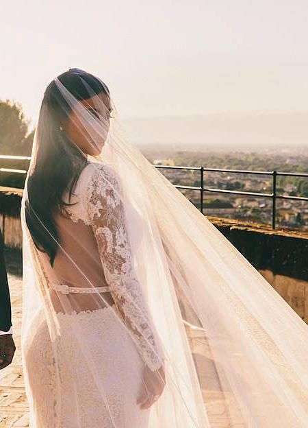 Kim Kardashian wore a couture wedding dress by Givenchy boasting intricate lace long sleeves. Givenchy Wedding Dress, Famous Brides, Iconic Wedding Dresses, Kardashian Wedding, Kim Kardashian Wedding, Famous Wedding Dresses, Couture Wedding Dress, Celebrity Bride, Iconic Weddings