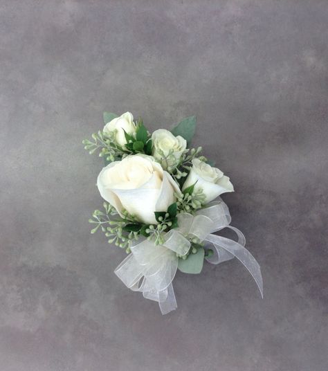 White rose corsage with seeded eucalyptus by Nancy at Belton Hyvee. Pin On Corsage Wedding, White Rose Corsage Wedding, White Corsage Wedding, White And Greenery Corsage, Sage Green And White Corsage, White Wedding Corsages For Mothers, White Green Corsage, Corsage Formal, White Rose And Eucalyptus Wrist Corsage