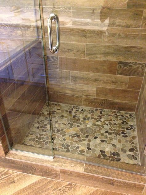 Showers With River Rock Floors, Bathroom Rock Tile Ideas, Cream Color Shower Tile, Pebble Shower Floor River Rocks, River Rock Shower Ideas, Pebble Floor Shower Ideas, Pebbles Bathroom, Wood Tile Shower Ideas, River Rock Shower Floor