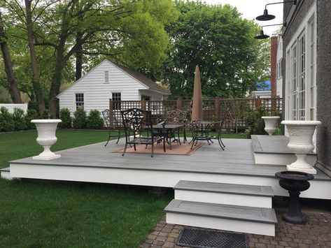 Beautiful 16' x 17'6" deck - 18" above ground with steps from the side and from the back.   Island Mist Trex decking and white pvc trim for fascia. Deck With Steps Down From House, Grey Trek Deck Ideas, Trex Patio Ideas, Small Trex Deck Ideas, Floating Trex Deck Ideas, White Trex Deck, Trex Decking, Low Decks Backyard Ground Level, Farmhouse Trex Deck