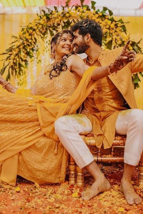 Want your Haldi ceremony to be the talk of the town? Steal the show with stunning Background Haldi Ceremony Decoration ideas we have curated for you to bookmark right away! Haldi Couple Photos, Haldi Poses For Couple, Haldi Couple Poses, Haldi Ceremony Couple, Groom Haldi Photoshoot, Haldi Photography Ideas For Bride, Couple Pose Wedding, Haldi Suit, Haldi Groom