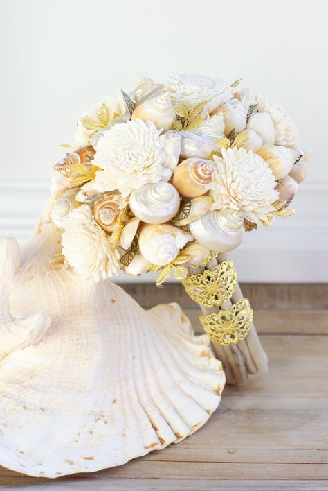 And they also do fun little accents like these iridescent sea shells for a beach-themed wedding #Wedding #Roses #Flowers Beach Themed Wedding Ideas, Preserved Wedding Flowers, Shell Bouquet, Beach Bouquet, Seashell Bouquet, Beach Theme Wedding Cakes, Shell Wedding, Cinnabon Cinnamon Rolls, Seashell Wedding