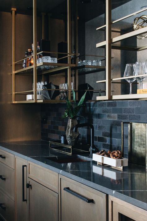 Wet Bar Dark Countertop, Metal And Glass Bar Shelving, Wetbar With Floating Shelves, Soapstone Wet Bar, Bar Backsplash Ideas Open Shelving, Moody Basement Kitchenette, Moody Bar Area, Dark And Moody Basement Bar, Black And Gold Basement Bar