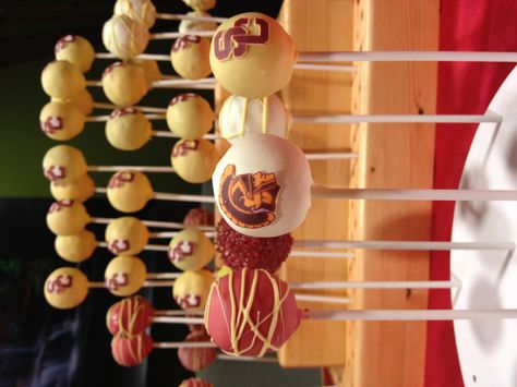 USC themed cake pops. Usc Grad Party, Usc Graduation Party Ideas, Usc Graduation Party, Usc Cake, Grad Treats, Usc Party, Usc Tailgate, Usc Graduation, Themed Cake Pops