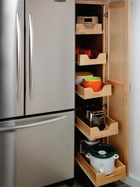 Efficient kitchen vertical storage idea with pull out drawers. #kitchen #storage #organization #cupboards #cabinets #shelves #decoratingideas #decorhomeideas #drawers Vertical Pull Out Cabinet, Pull Out Spice Rack Next To Fridge, Pull Out Appliance Cabinet, Pull Out Larder Cupboard, Narrow Pull Out Cabinet, Pull Out Drawers Kitchen, Narrow Kitchen Cabinet Ideas, Pantry Drawers Pull Out Shelves, Pull Out Kitchen Cabinets