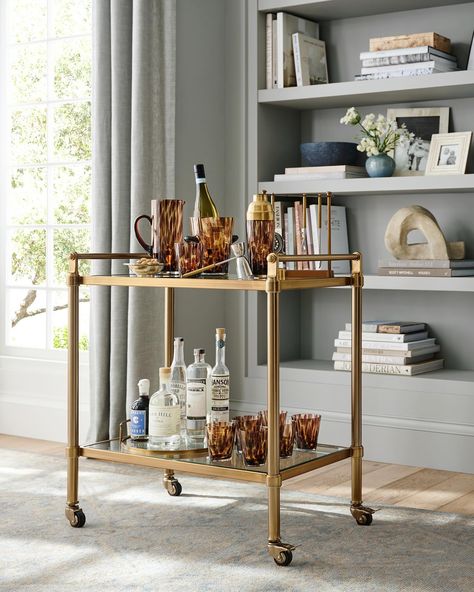 An elevated classic, our Everson Collection comes in an Antique Brass finish. The clean lines and clear surfaces keep your space looking open and light. Swipe to view the full collection. Brass Bar Cart, Metal Bar Cart, Gold Bar Cart, Home Bar Sets, Bar Cart Styling, Bar Storage, Glassware Storage, Home Bar Furniture, Wine Rack Wall