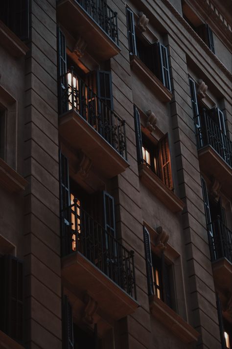 Building at night with lit up apartments with small balconies. Contrast windows, warm colour, aesthetic building, dark aesthetic. #cityaesthetic #cityatnight #barcelonacity #darkeashetic #nightlife #vibey #streetphotography Apartment Balcony Aesthetic Night, Old Apartment Complex Aesthetic, Apartment Neighbors Aesthetic, Loft Apartment Exterior, Apartment At Night, Night Balcony, Condo Style, European Apartment, Building At Night