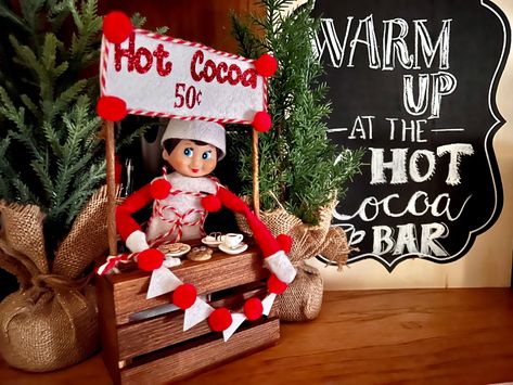 My friend made and let me borrow this amazing hot cocoa stand! Loving it! Paired well with the hot cocoa stand from two years ago Elf Hot Cocoa Ideas, Elf Hot Cocoa Bar, Elf On The Shelf Hot Cocoa Bar, Elf Hot Chocolate, Hot Cocoa Elf On The Shelf, Elf Hot Cocoa, Hot Cocoa Stand Christmas Pictures, Elf On The Shelf Ideas Hot Cocoa Bomb, Hot Cocoa Stand