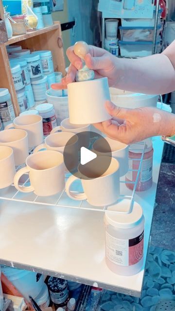 Shawna Pincus on Instagram: "Glaze time! Giving everything a coat of my white satin glaze before adding the prints. 

I’m using my homemade #magnet tool to help me hold the mugs for dipping. I have a tutorial on how I made them a little ways back in my feed if you are curious what they are. 

The white grate placed on some glaze jars gives me enough space to set the mug down and remove the magnet tool while the mug is still wet. 💦

I’m hoping to get a glaze kiln firing this weekend but also the pool is calling my name! It’s our last week to enjoy some swim time so we’ll see what happens🏊‍♀️☀️

Happy Friday!! 
.
.
.
#fastmotionfriday #glazing #pottery #ceramics #homemadetools #problemsolving #creativeminds #artist #ceramicsstudio" Dip Glazing Pottery, Glazing Pottery, Pottery Cafe, Fast Motion, Glazed Pottery, Ceramic Techniques, Homemade Tools, Kiln Firing, Pottery Ceramics