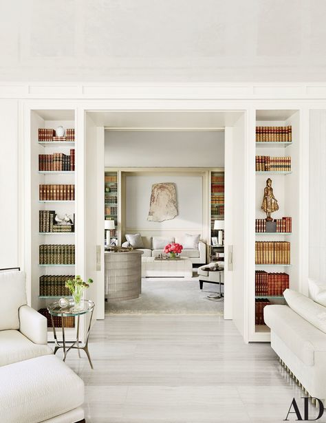 A view into the library, where a Bartolomeu Cid dos Santos stone relief is displayed above the sofa; the small table in the foreground is by Holly Hunt. Home Library Design, Home Libraries, A Living Room, Home Library, Book Shelf, Architectural Digest, Built Ins, Contemporary House, Bookshelves