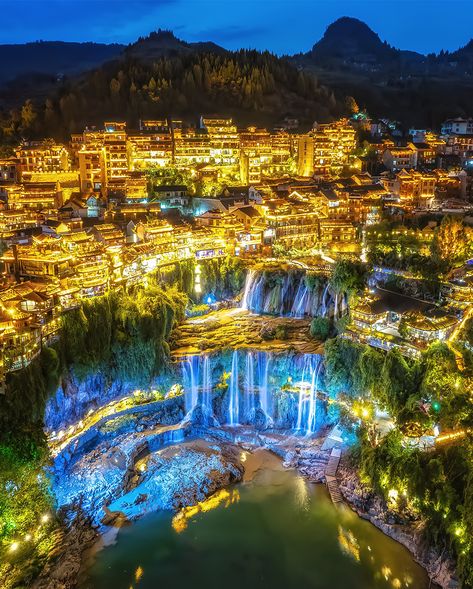 The ancient town of Furong, China, seems like something out of a fantasy novel in our #SightSeeingSunday image of the week. Also known as Furong Ancient Town, the town is situated above the Wangcun waterfall and is over 2,000 years old. It is a rare and ancient gem of the Hunan Province of China.

Have a fabulous Sunday!

#travelphotography #beautifuldestinations #sightseeing #sightseeings #travel #sundayvibes  #sundayvibes #beautifulplaces #travelgoals Furong China, Furong Town, Gansu China, China Waterfall, Chinese Mountain Village, Furong Ancient Town, China Floating Mountains, Furong Town China, China Ancient Town