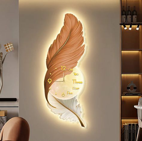 Add a touch of elegance and nature to your home with our Bella Donna Feather Wall Clock + Light. This decorative clock + light fixture is shaped like a large feather and accented with a glamorous gold details. #lightfixture #wallclock #lightfixtures #clocks Living Room Wall Clock, Best Wall Clocks, Wall Clock Light, Wall Clock Design, Feather Wall, Clock Art, Cute Bedroom Decor, Wall Decor Design, Large Clock