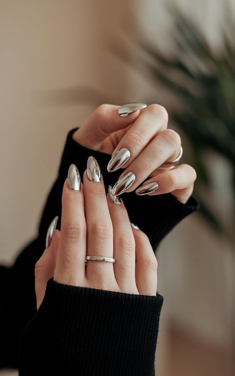 Achieve a sleek, sophisticated look with silver chrome nails this winter. The perfect blend of bold and elegant, these nails complement both casual and formal attire. Add a touch of sparkle to your fingertips and shine all season long! #SilverChromeNails #WinterBeauty #MetallicManicure #ElegantNails #WinterFashion Chromatic Nails Silver, Nye Chrome Nails, Silver Mirror Nails, New Years Nails Chrome, Cool Chrome Nails, Edgy Winter Nails, Gray Chrome Nails, Cute Chrome Nails, Winter Chrome Nails