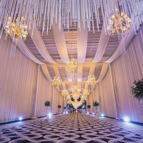 Scalloped drapes with pretty chandeliers makes up for one of the latest ceiling decor ideas.  #decorinspo #decorinspiration #designdecor #decordesign #eventdecor #decorlove #weddingdecor #weddingflowers #weddingdecoration #weddingvenue#eventdesign Wedding Ceiling Decorations, Wedding Ceiling, Ceiling Draping, Wedding Hall Decorations, Wedding Entrance Decor, Marriage Decoration, Desi Wedding Decor, Tent Decorations, Wedding Design Decoration