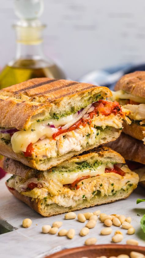 Italian Chicken Panini Recipe is made up of crusty bread filled with gooey mozzarella cheese, roasted red pepper, shredded chicken and lots of garlicky pesto. #chickenpanini #paninirecipe #paninisandwich www.savoryexperiments.com Chicken Bacon Pesto Sandwich, Frontega Chicken Panini Copycat, Cibatta Paninis Recipe, Italian Chicken Panini, Focaccia Chicken Sandwich, Best Bread For Panini Sandwiches, Best Bread For Panini, Panini Recipes Healthy, Vegetable Panini