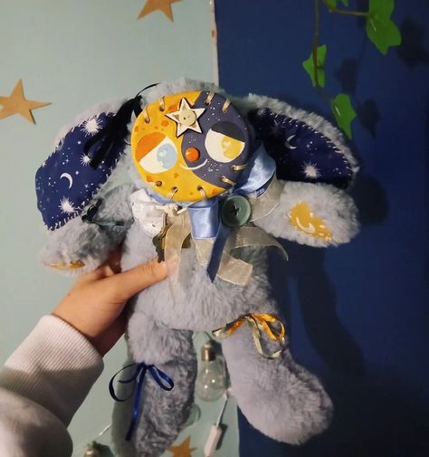 Image shows a customised blue-grey rabbit plush with a sewn-on clay face, which is painted to look like a moon. Snuggled In Bed, Clay Stuffed Animal Face, Clay Face Plushies Clown, Two Headed Plush, Art Plushies, Plush With Clay Face, Clay Plush Face, Star Stuffed Animal, Clay Plushies