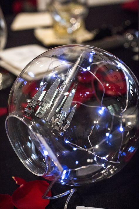 Our centerpieces for our Mass Effect wedding. We used Metal Earth models in terrariums with fairy lights. Photo by Danielle Lirette Photography. Space Wedding Centerpieces, Galaxy Centerpiece Ideas Wedding, Star Wars Centerpieces Wedding, Mass Effect Wedding Ideas, Space Themed Wedding Reception, Cosmic Centerpiece, Star Wars Wedding Centerpieces, Space Theme Floral Centerpiece, Star Wars Centerpiece Wedding