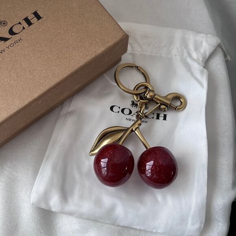 Coach Cherry Red Cherry Keychain Cute Wallet Keychain Ideas, Cute Wallet Keychain, Bag Keychain Ideas, Red Keychain Aesthetic, Cherry Red Accessories, Coach Wallet Keychain, Coach Cherry Charm, Cherry Car Accessories, Cherry Red Bag