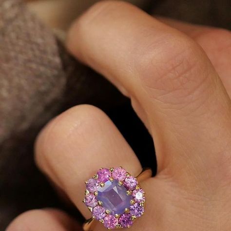 Berlinger Jewelry on Instagram: "Introducing our new Purple Sapphire Cluster Ring 💕 This ring has a cushion cut light purple sapphire center stone and ten opalescent pink/purple sapphires, making it a truly one of a kind ring. We’re obsessed with the opaque sparkle of the sapphires in this ring. It’s the perfect vintage look, with a colorful twist. Comment below if this is your dream ring ☺️ Purple Sapphire Cluster Ring (Product ID: B0741) #uniqueengagementring #vintageinspiredengagementring #engagementrings #ringoftheday #nontraditional #nontraditionalbride #artdeco #artdecojewelry #customjewelry #vintagerings #vintagejewellery #vintagestyle" Lilac Sapphire, Colorful Cluster Ring, Berlinger Jewelry, Nontraditional Bride, Purple Sapphire Ring, Vintage Cluster Ring, Vintage Engagement Rings Art Deco, Purple Sapphire, Art Deco Engagement Ring