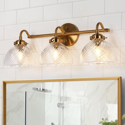 Enhance the atmosphere of your sophisticated bathroom, living room, or bedroom with our stunning 3-light dimmable bathroom vanity light. The captivating electroplated brass finishes seamlessly complement the textured dome glass shade, introducing a modern luxury feel to your cozy spaces. Elevate the aesthetic with Edison bulbs, incandescent, or dimmable LED bulbs, allowing you to customize the brightness to your preference. Please be aware that bulbs and a dimmer are not included, providing you Above Mirror Vanity Lights, Vintage Bathroom Light Fixtures Over Mirror, Vintage Gold Bathroom Fixtures, Traditional Bathroom Vanity Lights, Flower Vanity Light, Boho Bathroom Vanity Light, Victorian Bathroom Lighting, Vintage Bathroom Vanity Lighting, 4 Light Vanity Fixture Over Mirror