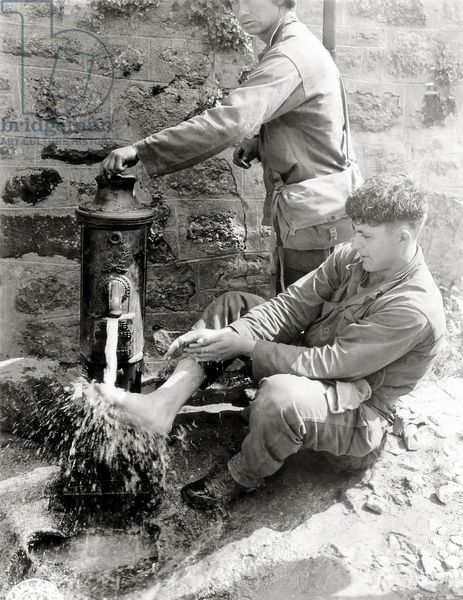 Private C. L. Scott of the 4th Infantry Division is washing his feet at a public fountain, Villedieu-les-stoves, Normandy, France, 2nd August 1944 (b/w photo) 4th Infantry Division, Battle Of Stalingrad, Greatest Generation, Wwii Photos, German Soldiers Ww2, German Uniforms, German Military, World Wars, Normandy France