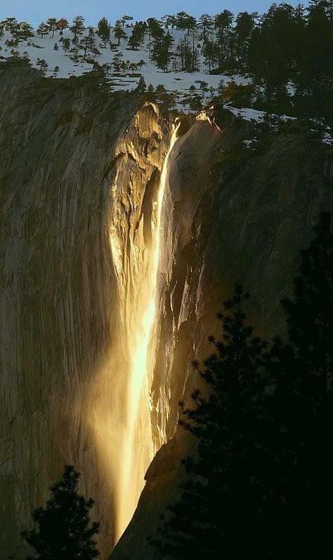 Once a year in Yellowstone National Park, the sun hits just right to make this waterfall appear golden in color. Horsetail Falls, Magic Places, Month Of February, Alam Yang Indah, Yosemite National Park, Pretty Places, On Fire, Amazing Nature, Natural Wonders