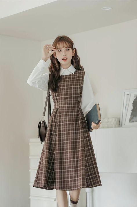 Round neck sleeveless plaid midi dress with thick shoulder straps in an all-over plaid print. Zips up at the back with a tie-waist and side pockets. Perfect for layering with your favorite blouse or sweater. S: 35" chest, 29" waist, 41.5" lengthM: 36.5" chest, 30.5" waist, 41.5" lengthL: 38" chest, 32" waist, 41.5" length Professor Clothes Women, Women Casual Dress Outfits, Turtle Neck With Dress Outfit, Plaid Pinafore Dress, How To Dress Preppy, Loafers With Dress Outfits, Classy Teacher Outfits, Korean Dress Ideas, Fall Outfits Petite Women