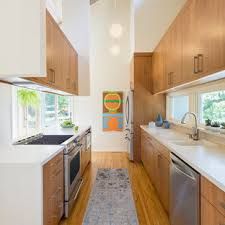 75 Beautiful Mid-Century Modern Kitchen with Brown Cabinets Pictures & Ideas - February, 2021 | Houzz Mid Century Modern Kitchen Remodel, Mid Century Modern Kitchen Design, Brown Kitchen Cabinets, Galley Kitchen Remodel, Bespoke Kitchen Design, Galley Kitchens, Narrow Kitchen, Brown Cabinets, Space Saving Kitchen