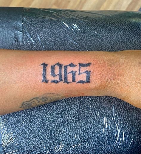 Old English writing tattoo “1965” birth year on arm Years Tattoo, Old English Font Tattoo, Old English Tattoo, 2023 Tattoo, Mama Tattoo, Tatuagem Masculina Pequena, Writing Tattoos, Old English Font, Tattoo Font