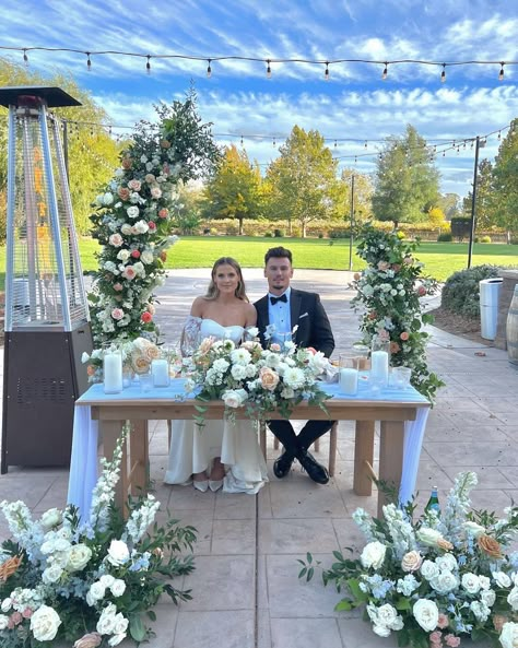 Bride and Groom head table and arch with dusty peach and hint of blue flowers Sweetheart Table Blue, Bride And Groom Head Table, Blue Sweetheart Table, Dusty Blue Sweetheart Table, Dusty Blue And Peach Wedding, Groom And Bride Table, Sweetheart Table Wedding Backdrop, Head Table Wedding Flowers, Sweetheart Table Backdrop