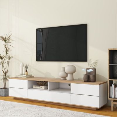 Modern TV stand with multi-functional storage keeps your TV area neat and organized. Whether you use your TV in your living room, bedroom, or entertainment room, this TV stand will meet your storage needs. Not only does it accommodate TVs up to 80 inches, but it also offers plenty of storage space to make your life easier. Color: White | Fu Owner 70.8" W Storage Credenza Wood in White | 16.1 H x 70.8 W x 15 D in | Wayfair Wood And White Tv Stand, Grey Couch With White Tv Stand, White And Wood Tv Stand, Living Room Decor Tv Stands, White Tv Stand Decor, Living Room White And Wood, Tv Area In Bedroom, Tv Stands Ideas For Living Room, White Tv Stand Living Room