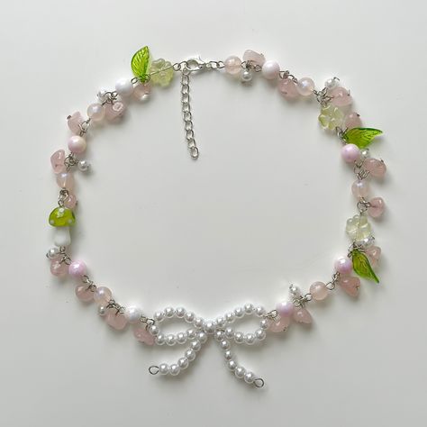 viiexu on depop !! | fairycore, cottagecore, necklace, pink, green, beaded accessories, ribbon, bow, handmade, accessories, meadow, mushroom, unique, aesthetic Fairy Accessories Aesthetic, Cottagecore Aesthetic Accessories, Green And Pink Jewellery, Fairy Core Accessories, Mushroom Unique, Beaded Necklace Aesthetic, Fairycore Accessories, Cottage Core Clothes, Cottagecore Necklace