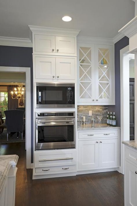 White glass doors above wet bar with crystal, bar glasses, etc. Wall Oven Kitchen, Kitchen Redo, Trendy Kitchen, Kitchen Remodel Idea, Wet Bar, Wall Oven, White Cabinets, Beautiful Kitchens, The Room